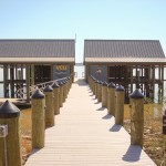 Government project: VCU Rice Center Boathouses, pier and floating dock, designed especially for the James River. Six covered boat slips with lifts, 150' of synthetic decking, 600 sf of synthetic roofing, floating dock with gangway, capped pilings with elec.