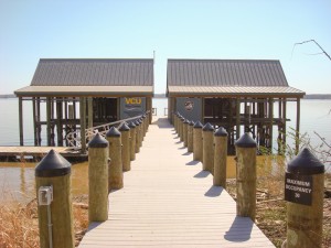 Government project: VCU Rice Center Boathouses, pier and floating dock, designed especially for the James River. Six covered boat slips with lifts, 150' of synthetic decking, 600 sf of synthetic roofing, floating dock with gangway, capped pilings with elec.